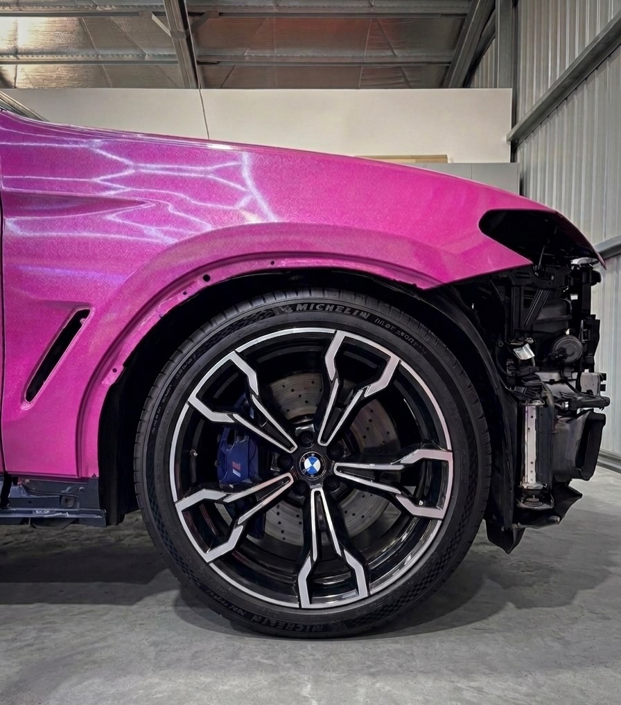 Pink wrapped BMW with gloss black wheels and blue calipers
